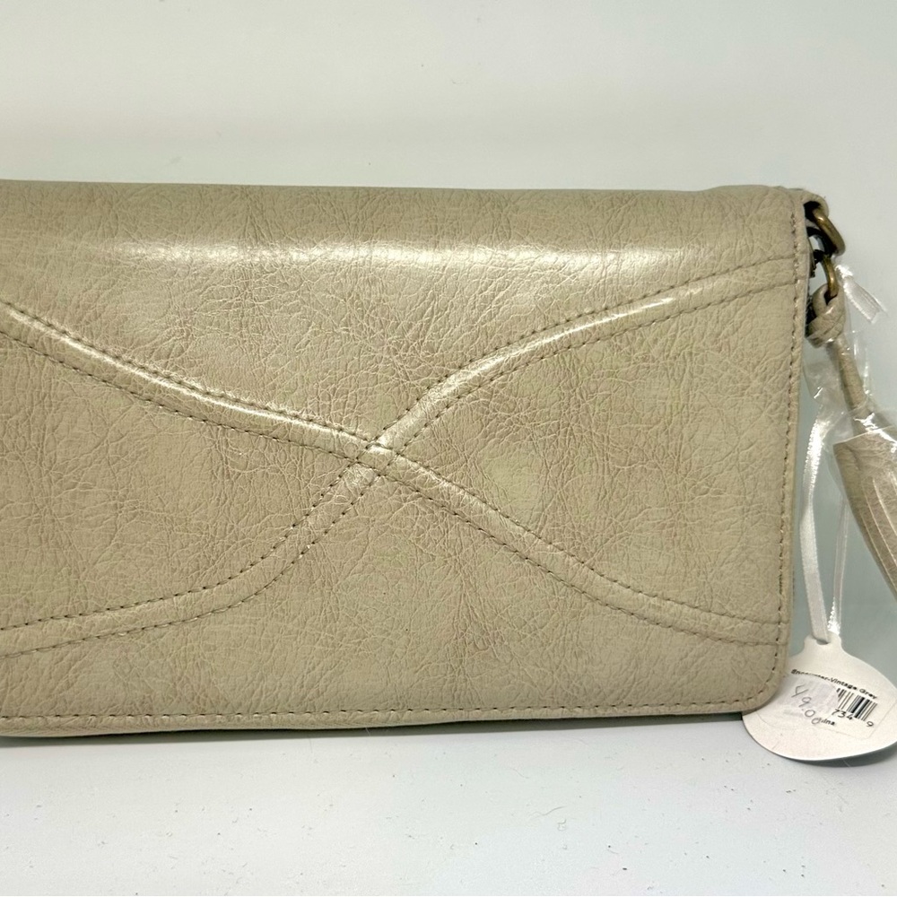 Sleek Cream Crossbody Bag with Tassel Detail